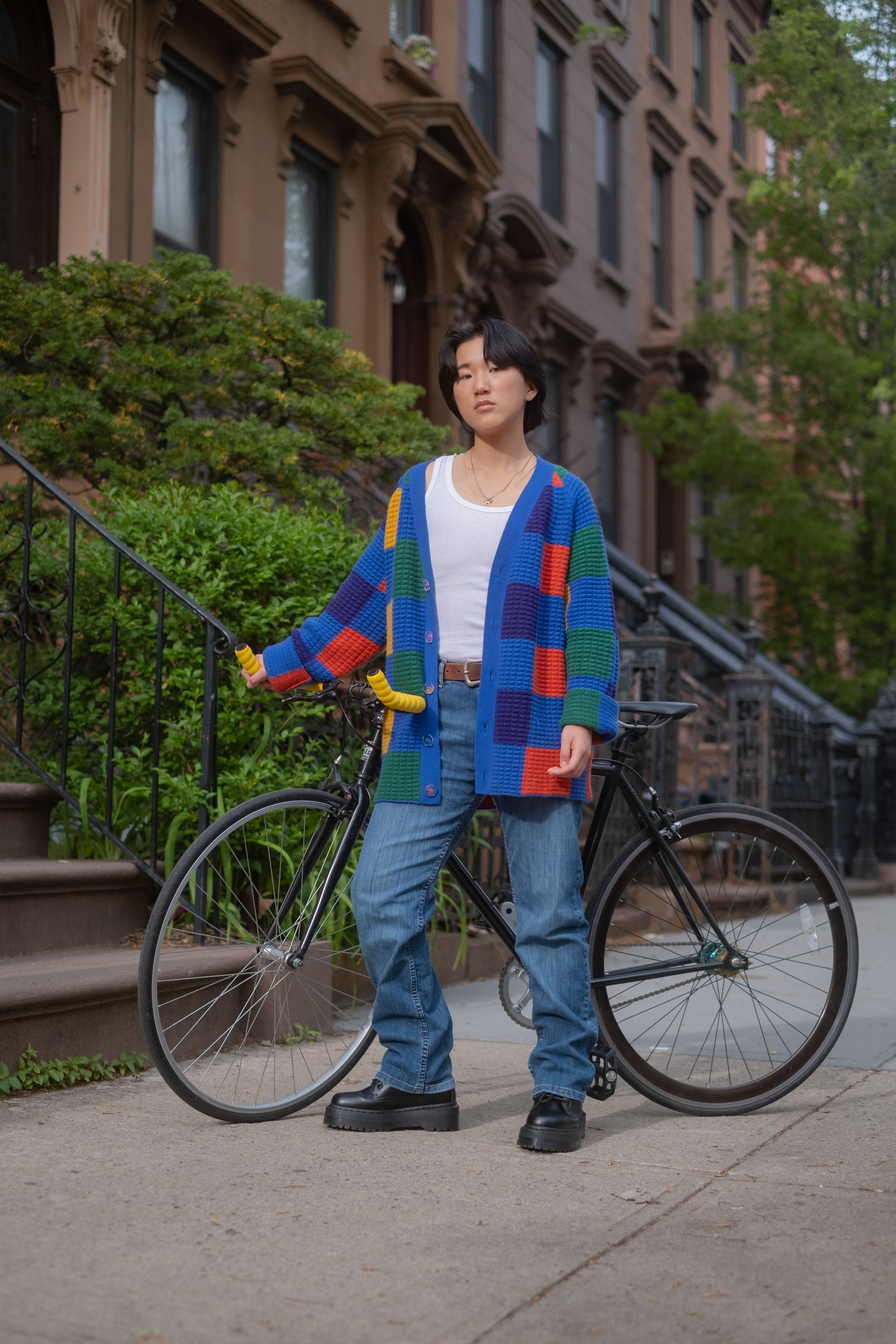 A non-binary trans man standing outside with a bicycle(1)